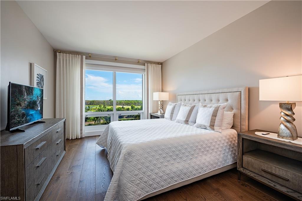 13915 Old Coast Road, Unit 602 Naples, FL 34110 - Photo 17 of 37 a bedroom with a large bed and a flat tv screen on dresser