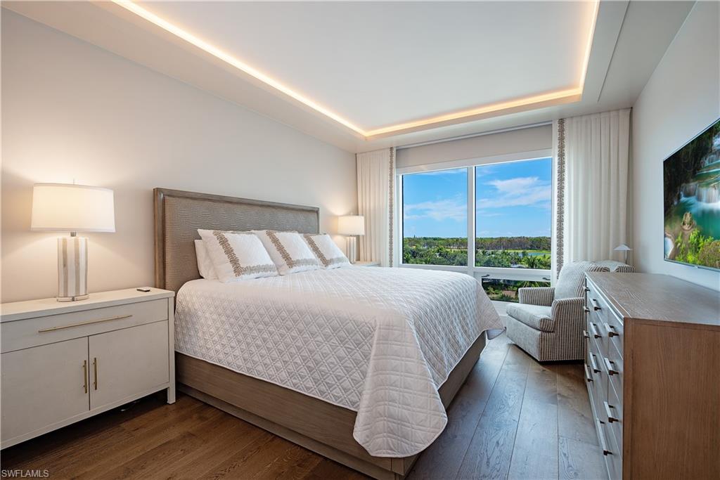 13915 Old Coast Road, Unit 602 Naples, FL 34110 - Photo 19 of 37 a bedroom with a large bed and a large window