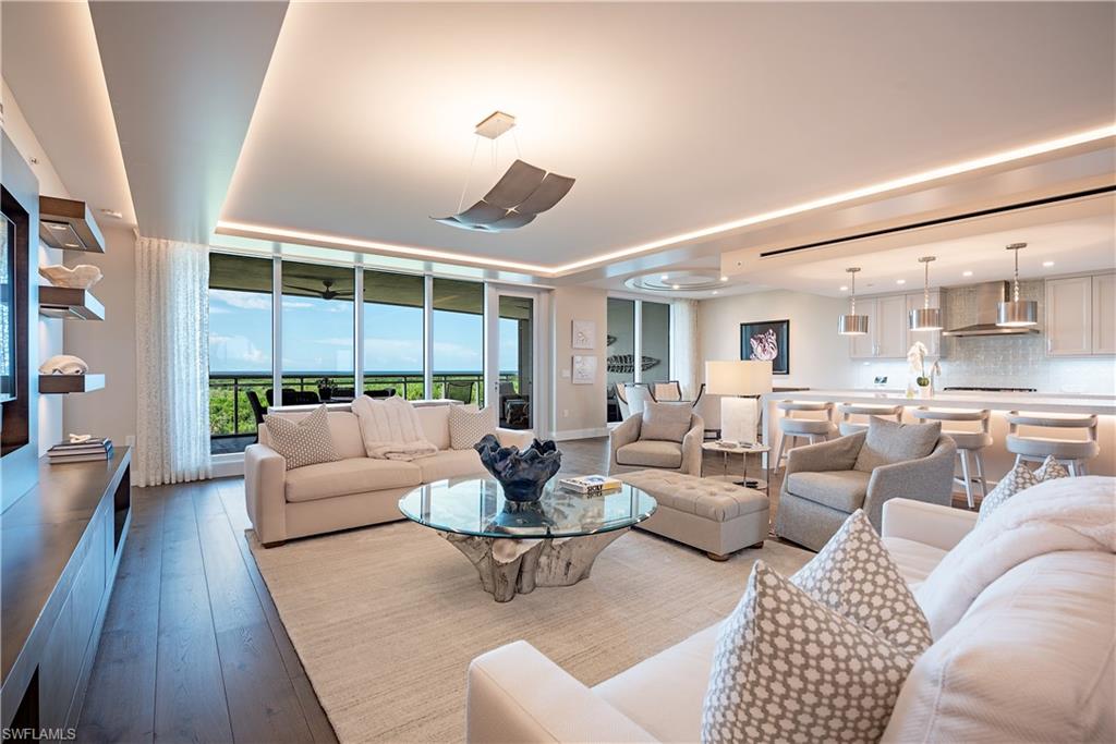 13915 Old Coast Road, Unit 602 Naples, FL 34110 - Photo 2 of 37 a living room with furniture and a large window