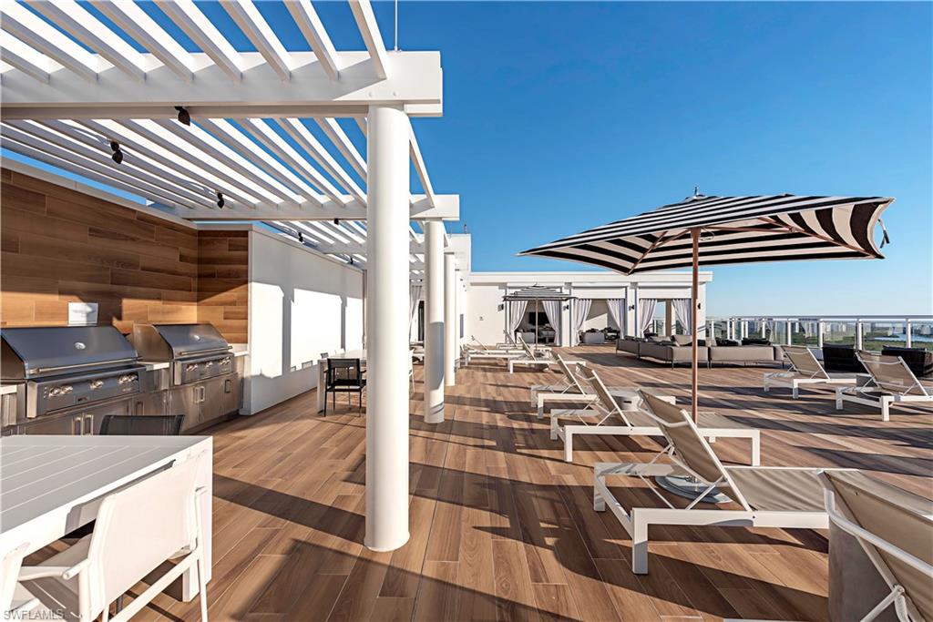 13915 Old Coast Road, Unit 602 Naples, FL 34110 - Photo 25 of 37 a view of a living room and kitchen area