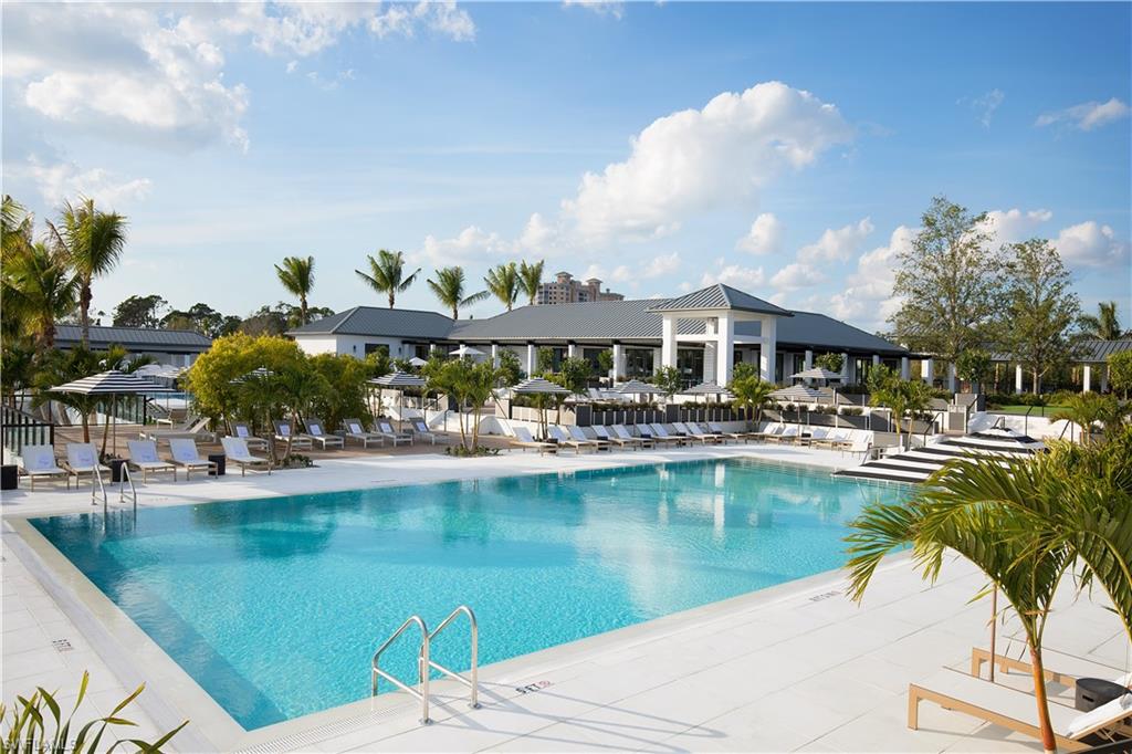 13915 Old Coast Road, Unit 602 Naples, FL 34110 - Photo 32 of 37 a view of swimming pool with outdoor seating and garden