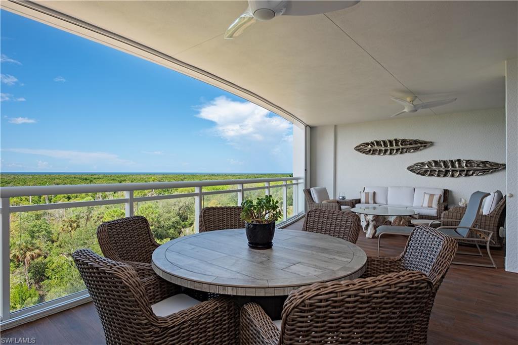 13915 Old Coast Road, Unit 602 Naples, FL 34110 - Photo 7 of 37 a view of a dining room with furniture and wooden floor