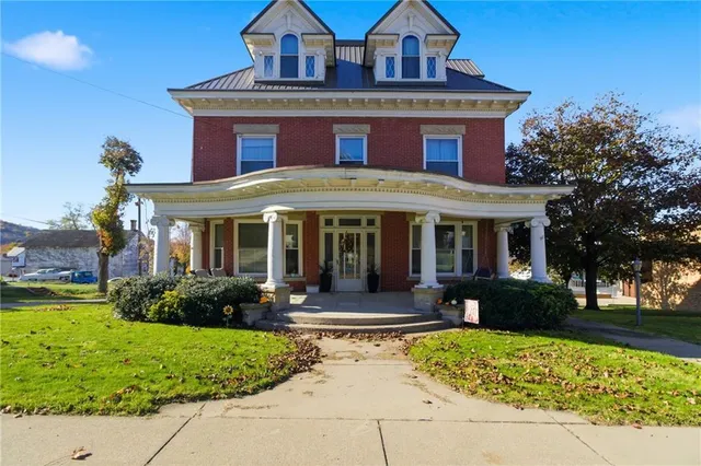 a front view of a house with garden