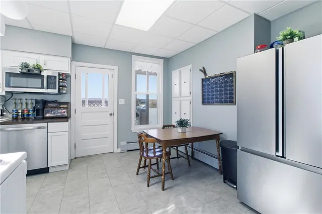 a kitchen with stainless steel appliances a refrigerator and a table