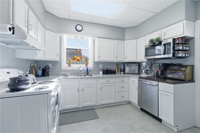 a kitchen with stainless steel appliances granite countertop a sink and cabinets