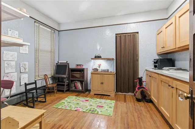 a kitchen with a refrigerator and a stove top oven