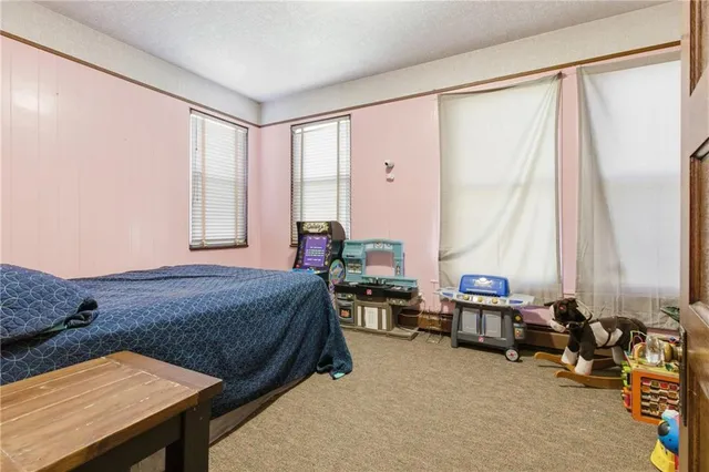 a bedroom with furniture and a window