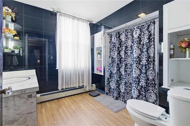 a bathroom with a toilet and shower curtain