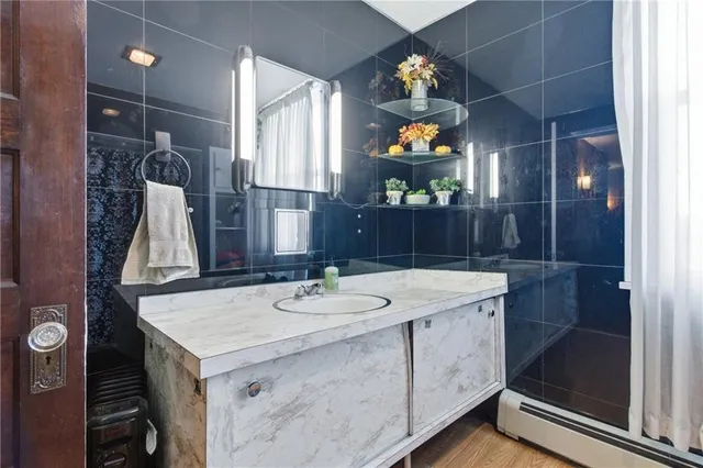 a bathroom with a sink mirror and vanity