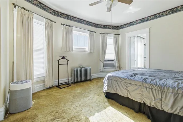 a spacious bedroom with a bed and a window