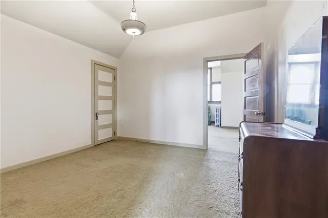 an empty room with windows and entrance