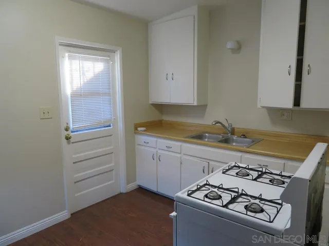 a kitchen with a stove and a refrigerator