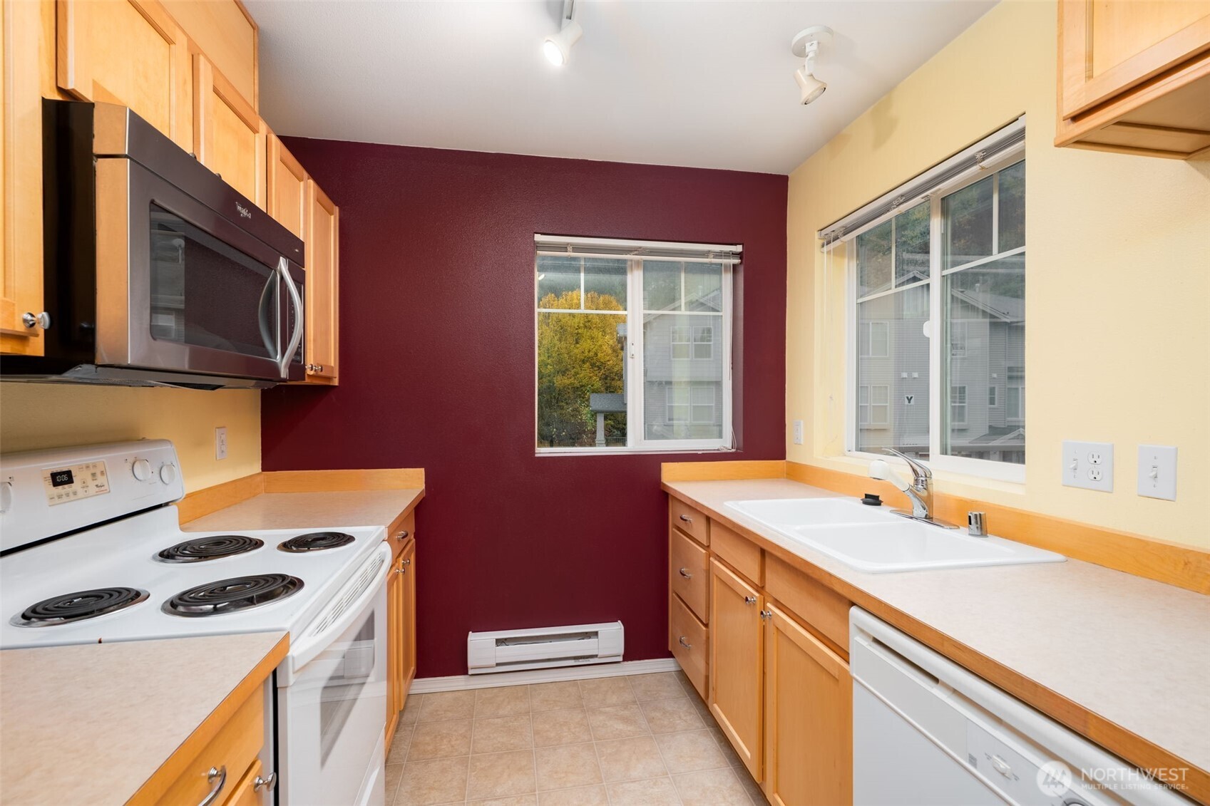 15325 Southeast 155th Place, Unit X4 Renton, WA 98058 - Photo 12 of 23 a kitchen with a sink stove and microwave