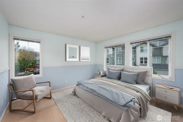 a bedroom with a large bed and a window