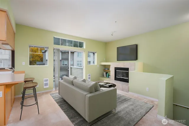 a living room with furniture a fireplace and a flat screen tv