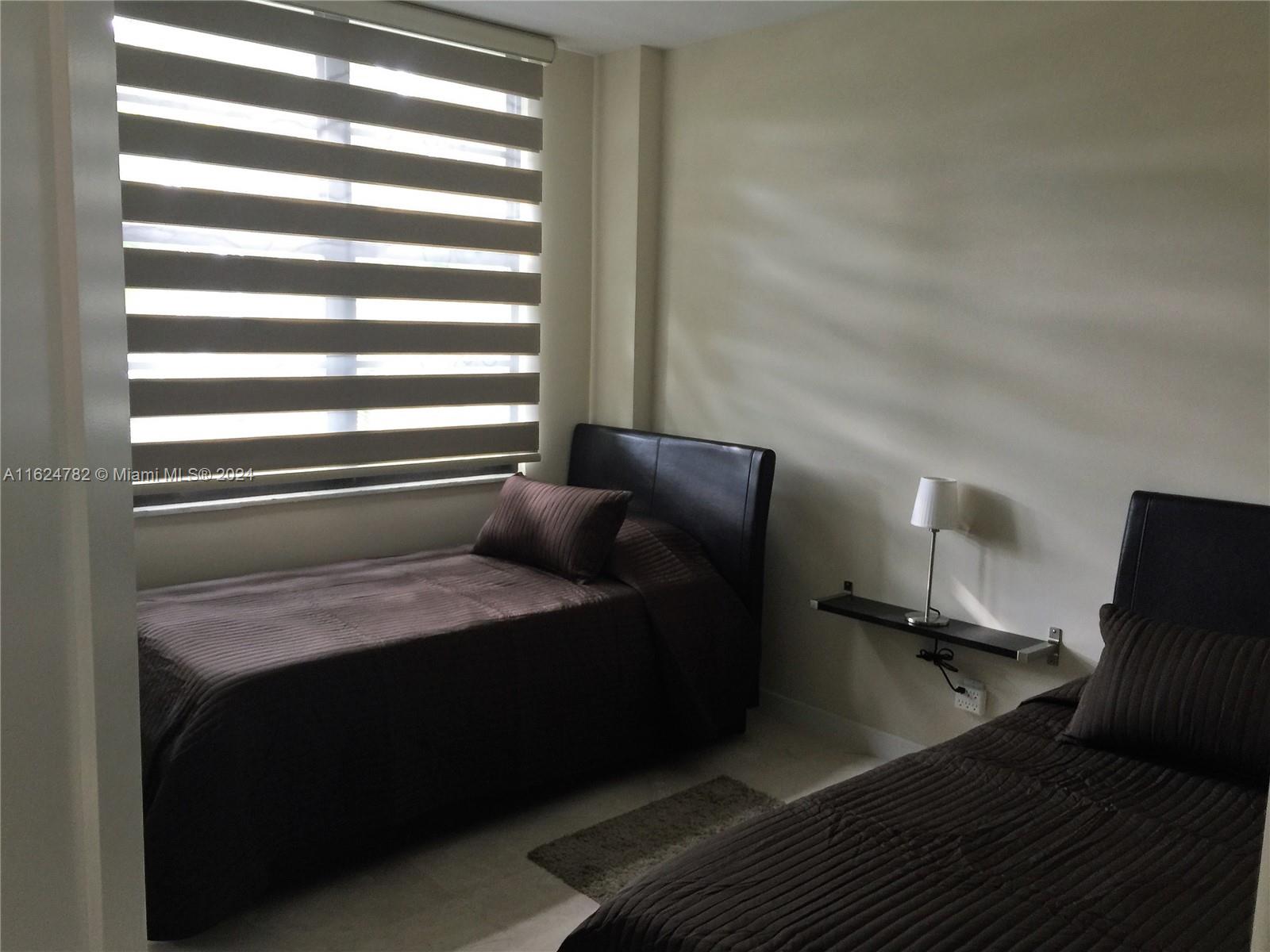 5161 Collins Avenue, Unit 207 Miami Beach, FL 33140 - Photo 4 of 7 a room with a bed and a window