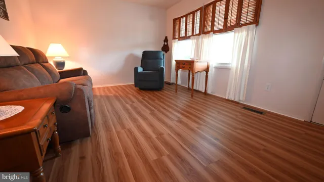 a view of a livingroom with furniture and wooden floor