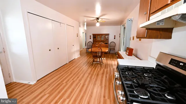 a kitchen with a sink and wooden floor
