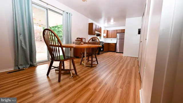 a view of a dining room with furniture window and wooden floor