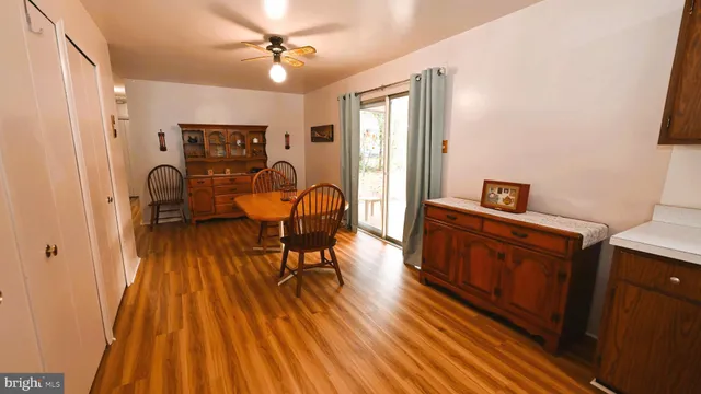 a view of a workspace with furniture and wooden floor