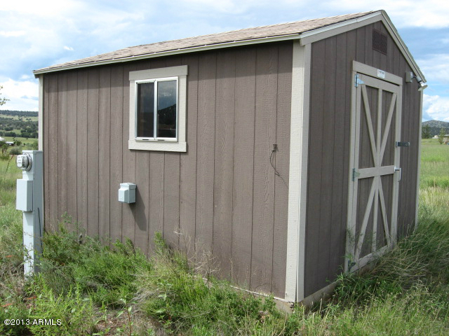 279 Rolling Hills Road, Unit X Young, AZ 85554 - Photo 11 of 13 a brick house with front door