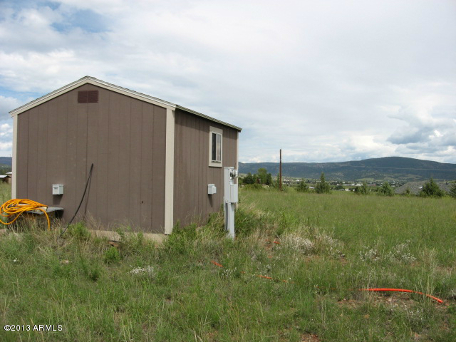 279 Rolling Hills Road, Unit X Young, AZ 85554 - Photo 13 of 13 a backyard of a house with lots of green space and lake view