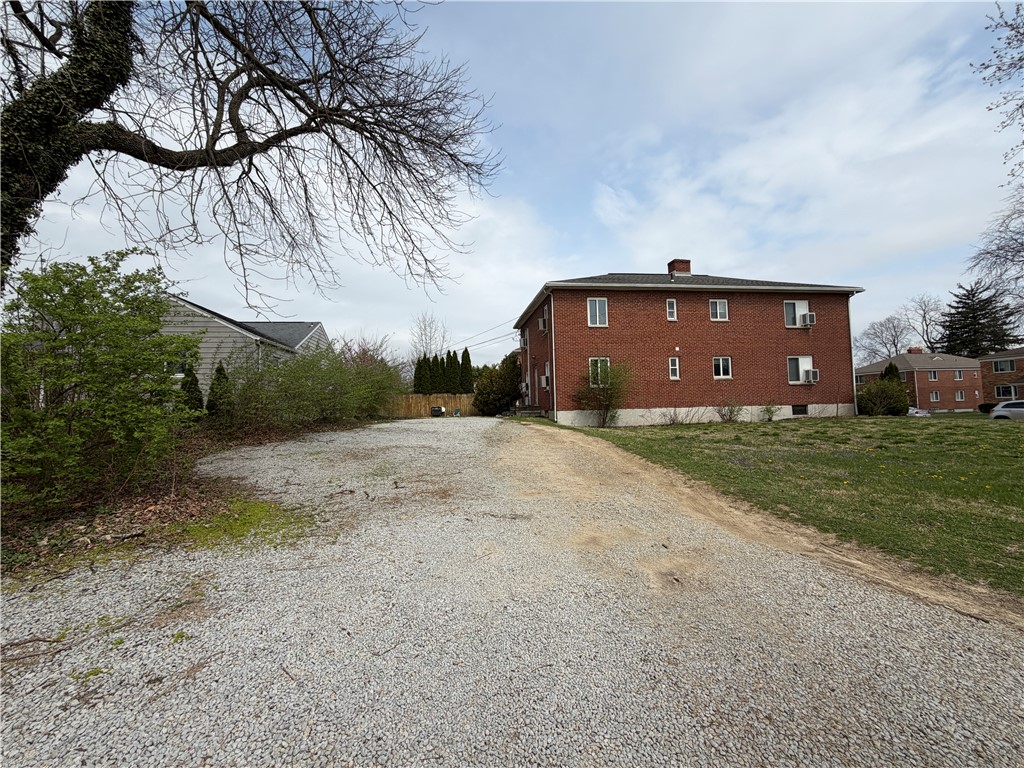 2825 San Rae Drive Dayton, OH 45419 - Photo 2 of 2 This expansive gravel lot offers ample parking and leads to a classic brick building.