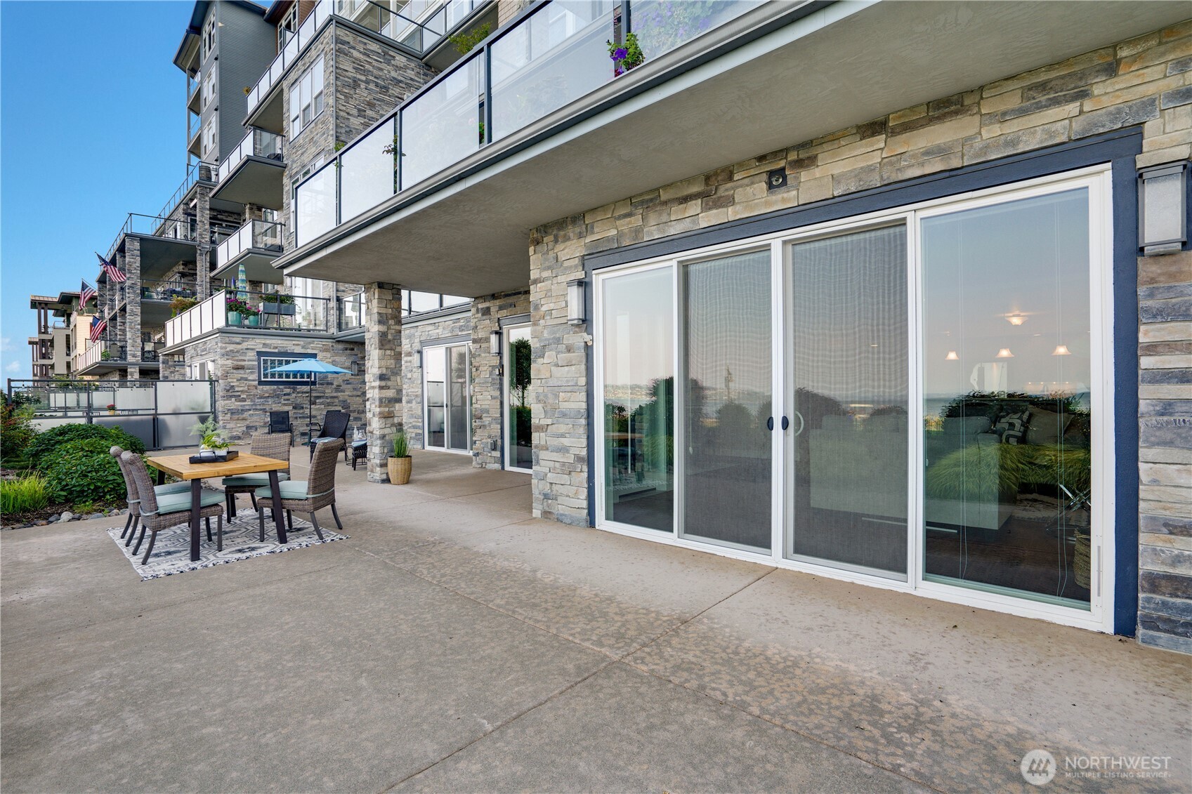 5105 Grand Loop, Unit 105 Tacoma, WA 98407 - Photo 13 of 39 a view of a building with a table and chairs