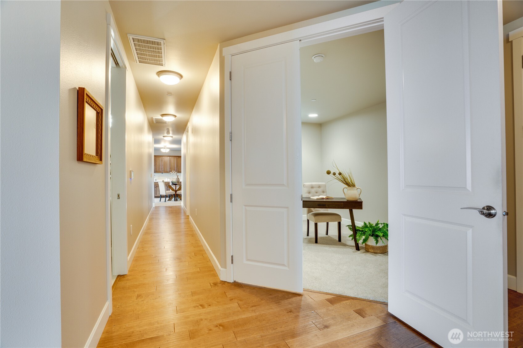 5105 Grand Loop, Unit 105 Tacoma, WA 98407 - Photo 18 of 39 a view of a hallway with wooden floor and a bathroom