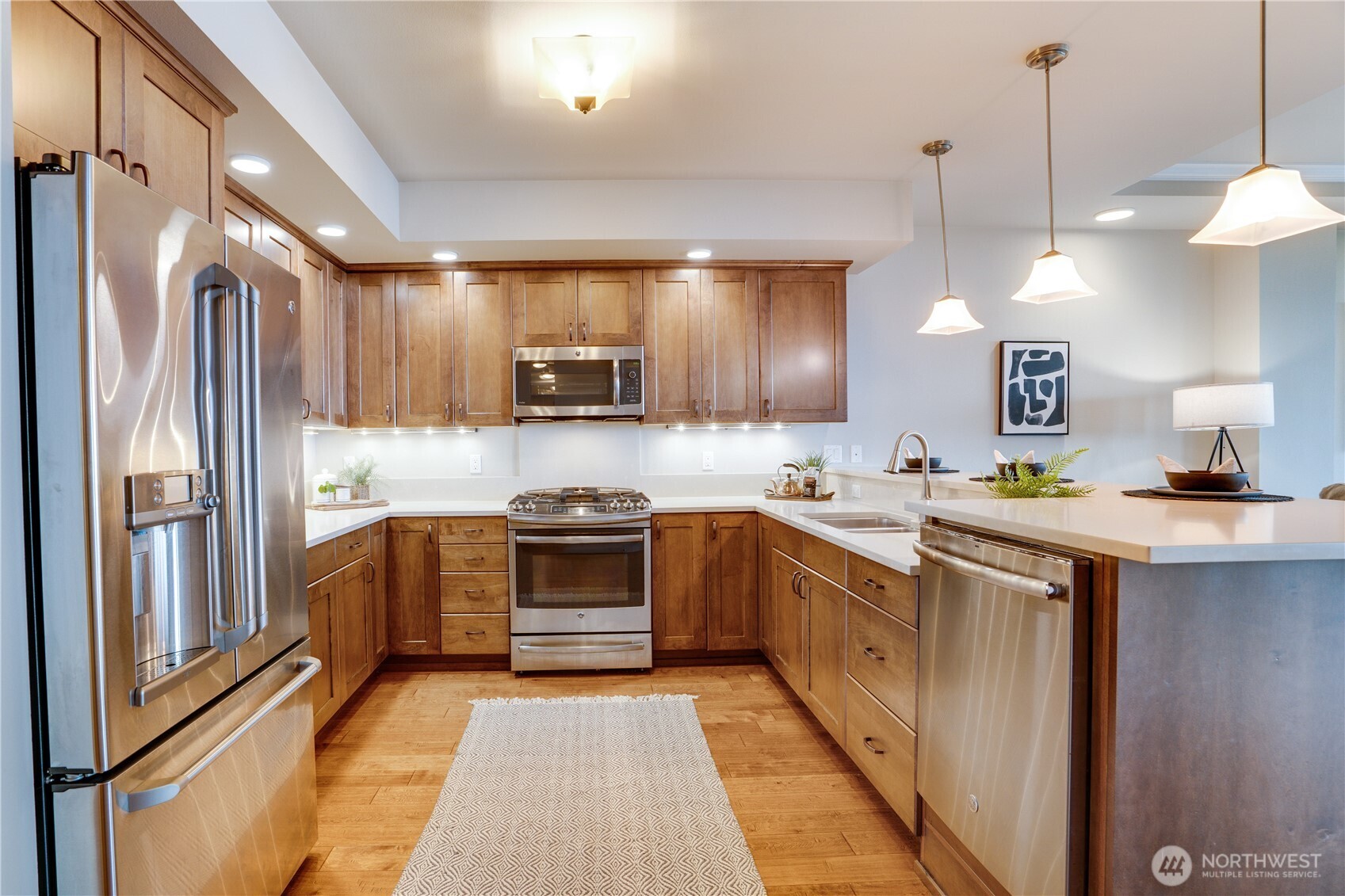 5105 Grand Loop, Unit 105 Tacoma, WA 98407 - Photo 7 of 39 a kitchen with stainless steel appliances granite countertop a refrigerator a sink a stove top oven and a refrigerator