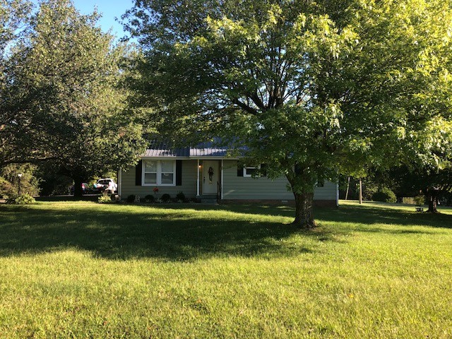 424 Dorris Road Portland, TN 37148 - Photo 2 of 48 a front view of a house with a yard garage and outdoor seating