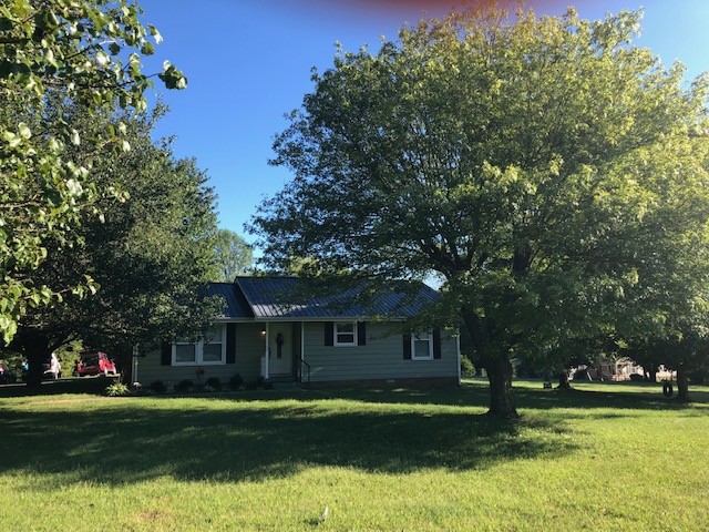 424 Dorris Road Portland, TN 37148 - Photo 3 of 48 a front view of a house with a garden