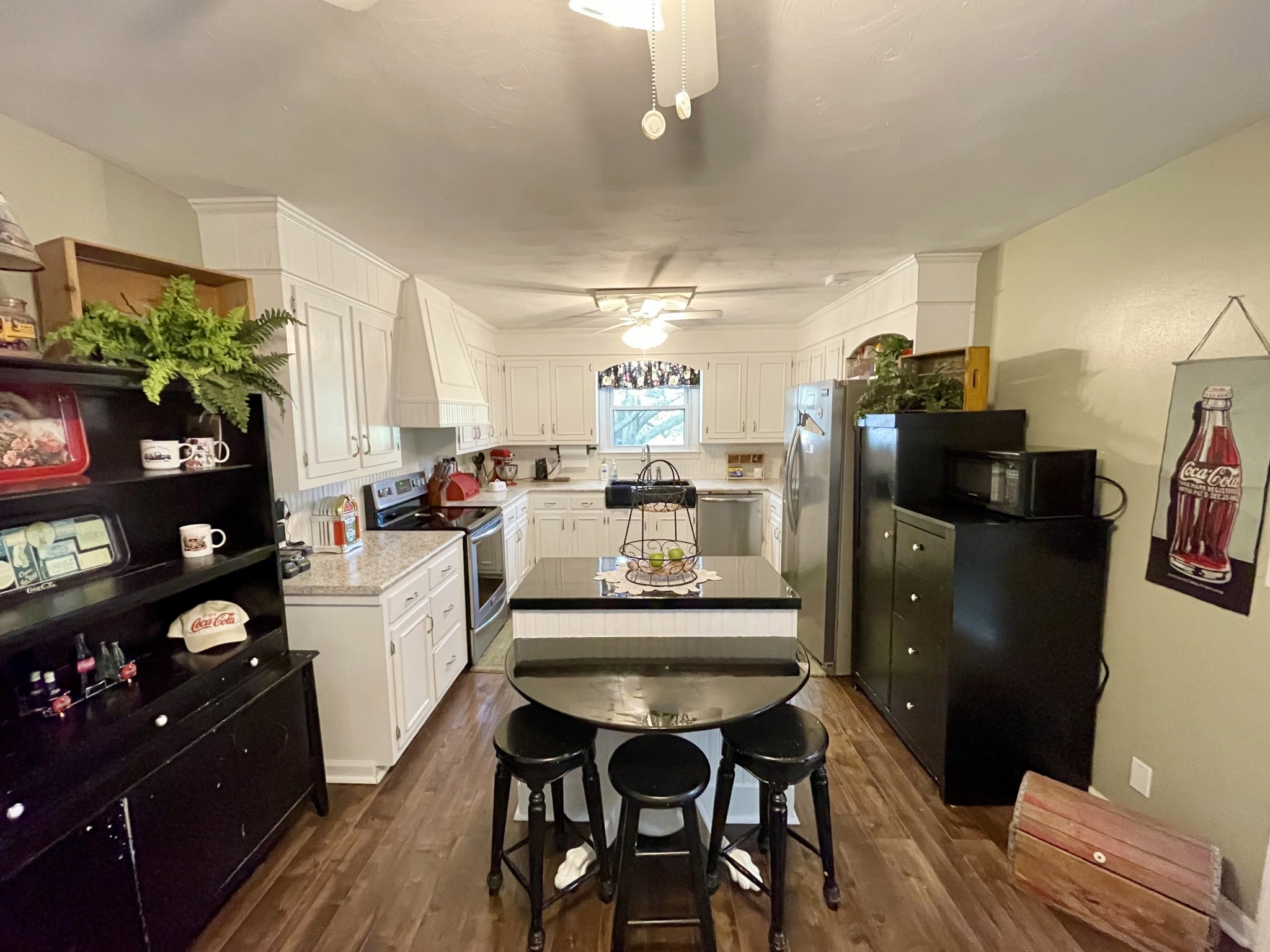 424 Dorris Road Portland, TN 37148 - Photo 38 of 48 a kitchen with stainless steel appliances kitchen island granite countertop a refrigerator a stove a sink a dining table and chairs with wooden floor