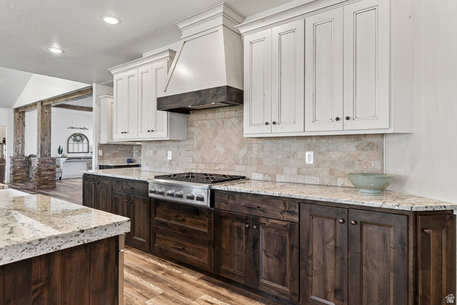 3311 West Allard Summit, UT 84772 - Photo 27 of 97 Gourmet kitchen featuring a built-in stainless steel gas range, herringbone tile backsplash, granite countertops, and two-tone cabinetry with upper white and lower dark wood-finish