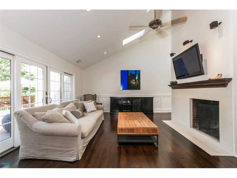 Undisclosed Address Riverside, CT 06878 - Photo 7 of 25 a living room with furniture a fireplace and a flat screen tv