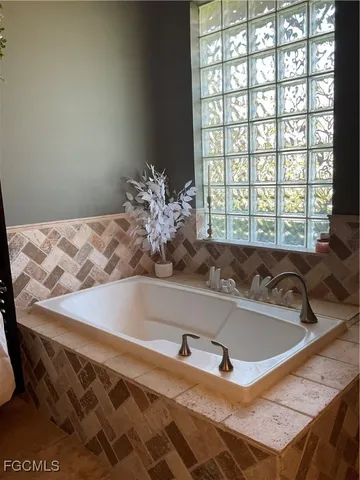 a bath tub sitting in a bathroom next to a window