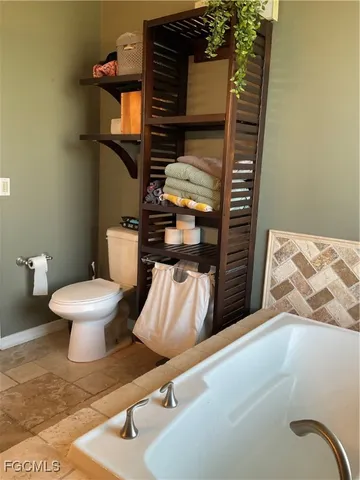 a bathroom with a toilet and a mirror