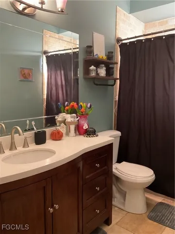 a bathroom with a sink vanity mirror and toilet