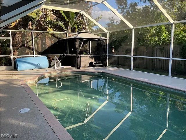 a view of small pool with seating area