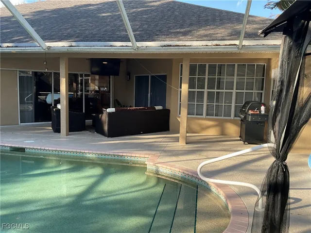 a view of a swimming pool with outdoor seating