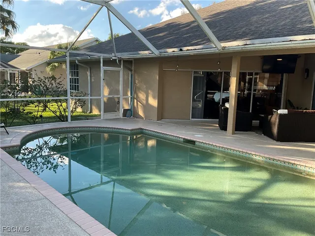 a swimming pool with outdoor seating