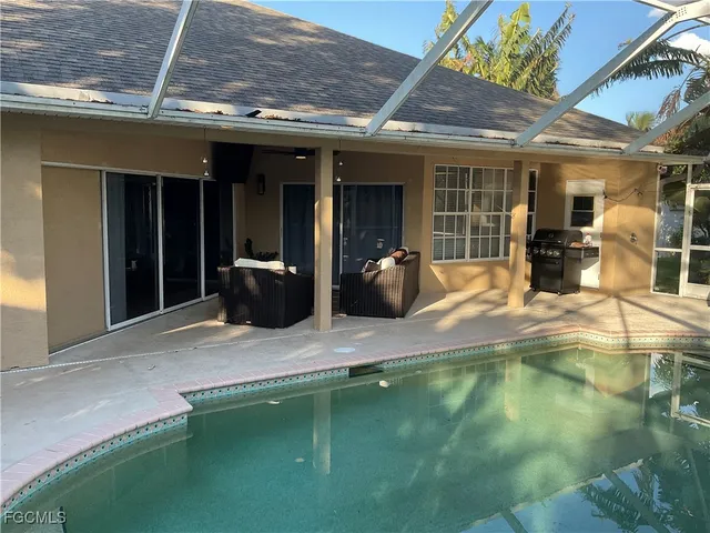 a view of a patio with table and chairs next to a yard