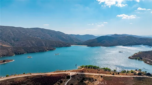 a view of a lake in middle of green field