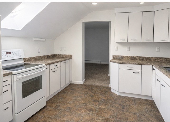 42 Mechanic Street Spencer, MA 01562 - Photo 2 of 9 a kitchen with granite countertop white cabinets and white appliances