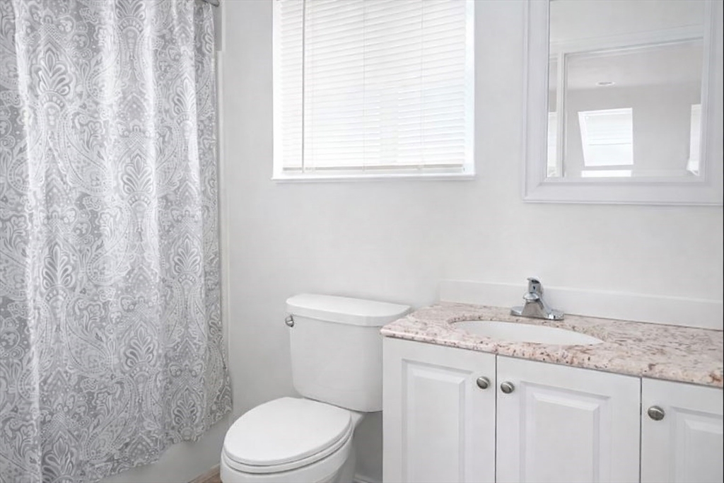 42 Mechanic Street Spencer, MA 01562 - Photo 5 of 9 a bathroom with a granite countertop toilet sink and mirror