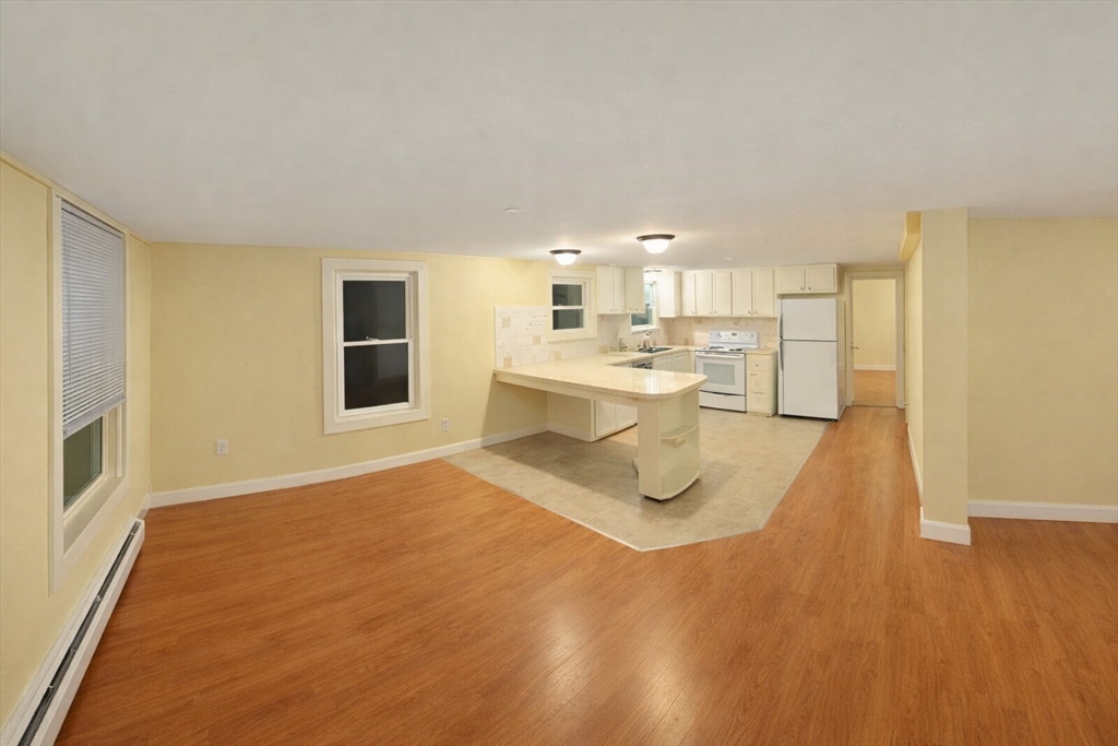 42 Mechanic Street Spencer, MA 01562 - Photo 7 of 9 a view of a kitchen with furniture and wooden floor