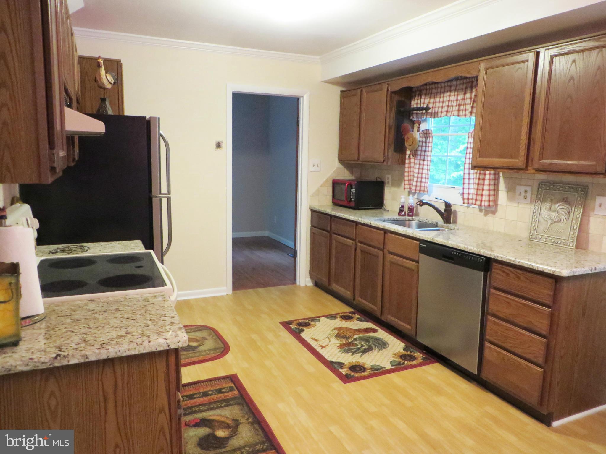 25085 Morgan Road Hollywood, MD 20636 - Photo 4 of 29 Kitchen has granite counters, tile backsplash