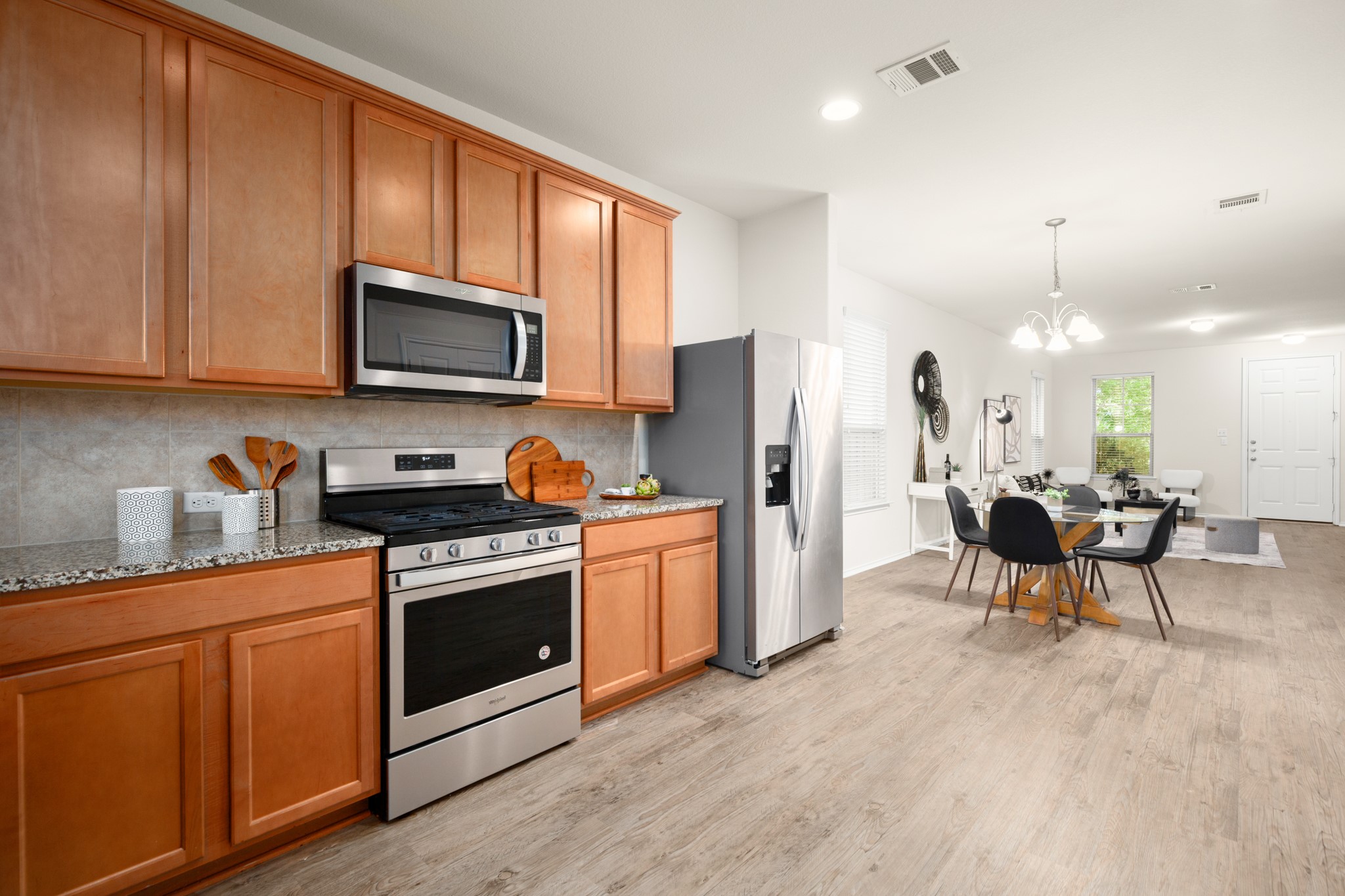380 Bonnet Boulevard Georgetown, TX 78628 - Photo 13 of 26 a kitchen with stainless steel appliances granite countertop a stove a sink a refrigerator a microwave and cabinets