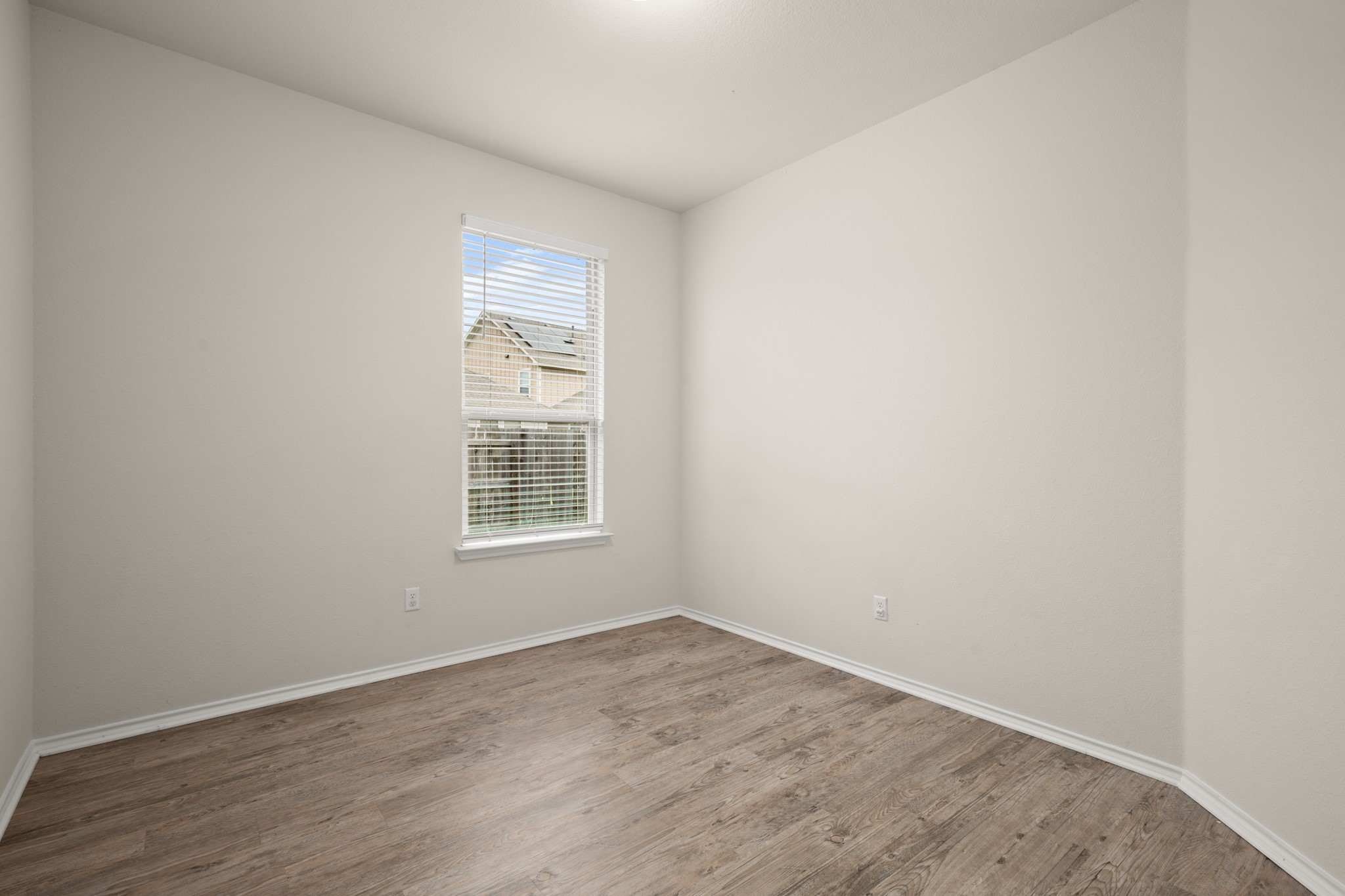 380 Bonnet Boulevard Georgetown, TX 78628 - Photo 21 of 26 a view of an empty room with wooden floor and a window