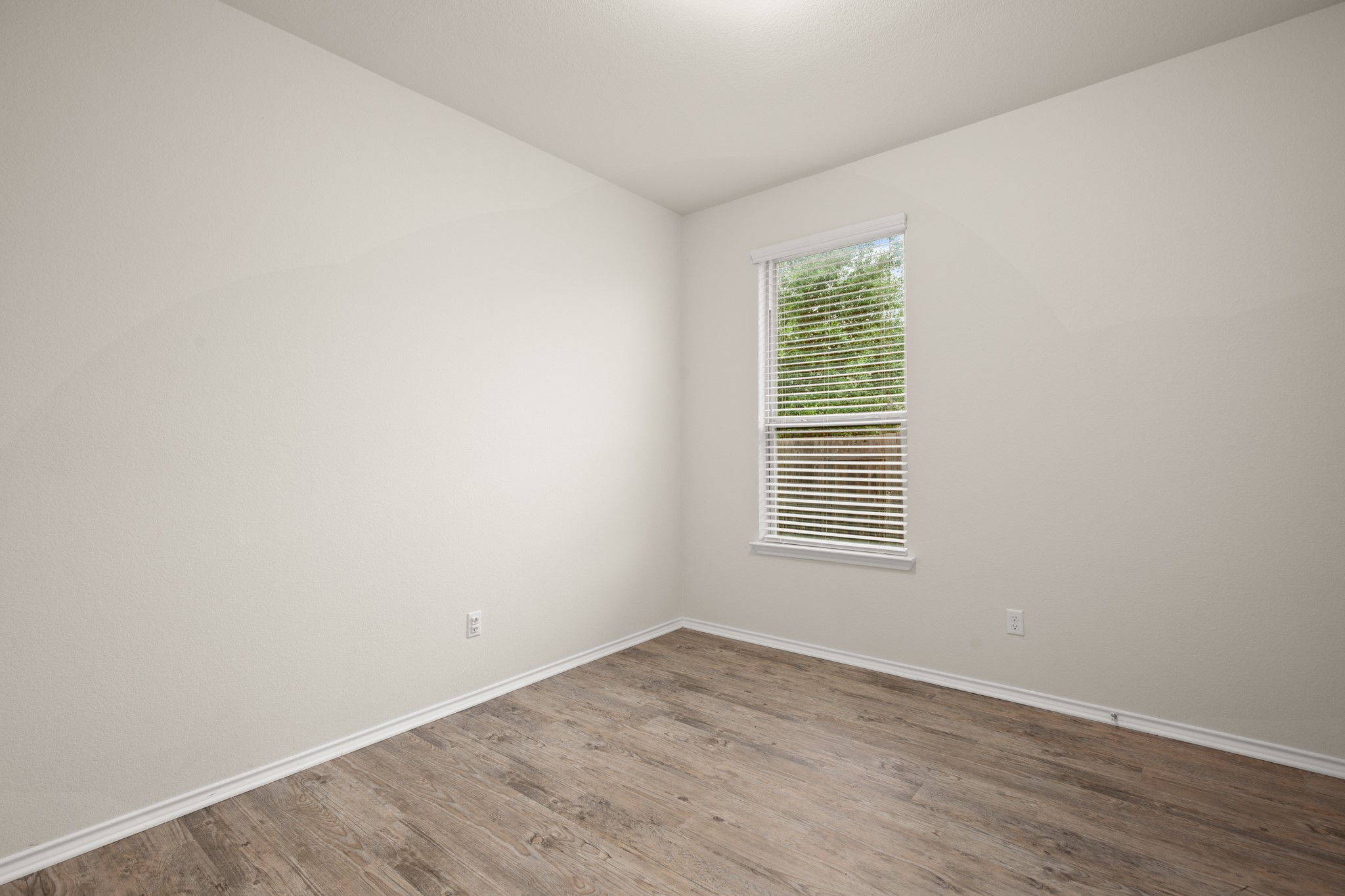 380 Bonnet Boulevard Georgetown, TX 78628 - Photo 22 of 26 a view of an empty room with wooden floor and a window